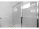 Bathroom with glass shower enclosure and white tiled walls at 8632 Snowfall St, Sarasota, FL 34241