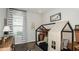 Cozy bedroom featuring a stylish tent bed, neutral decor, and natural light from a window at 8632 Snowfall St, Sarasota, FL 34241