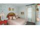 Charming bedroom with unique decor, a cozy bed, and a bright window and whimsical accents at 8632 Snowfall St, Sarasota, FL 34241