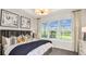 Inviting bedroom with a large window offering scenic views and stylish decor and furnishings at 8632 Snowfall St, Sarasota, FL 34241