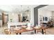 Elegant dining area with a modern table setting adjacent to the kitchen and living space at 8632 Snowfall St, Sarasota, FL 34241