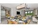 Modern dining area with a stylish table, contemporary lighting, and seamless access to the living room at 8632 Snowfall St, Sarasota, FL 34241