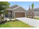 Charming one-story home featuring a well-manicured lawn and attached two-car garage at 8632 Snowfall St, Sarasota, FL 34241