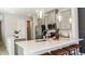 Modern kitchen features gray cabinets, stainless steel appliances, a white countertop and a breakfast bar at 8632 Snowfall St, Sarasota, FL 34241