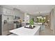 Spacious kitchen with stainless steel appliances, a center island, and seamless flow into the dining area at 8632 Snowfall St, Sarasota, FL 34241