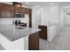 Kitchen featuring granite countertops, a stainless steel microwave and oven with stone-look tile flooring at 8632 Snowfall St, Sarasota, FL 34241