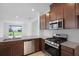 Modern kitchen featuring granite countertops, stainless steel appliances, and a view to the backyard at 8632 Snowfall St, Sarasota, FL 34241