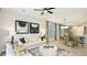 Open-concept living and dining area with modern furniture, neutral decor, and bright light fixtures at 8632 Snowfall St, Sarasota, FL 34241