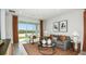 Bright living room with modern furniture, elegant decor, and a large glass door at 8632 Snowfall St, Sarasota, FL 34241