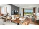 Bright and open living area with modern furniture, a dining table, and sliding glass doors to the outside at 8632 Snowfall St, Sarasota, FL 34241