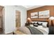 Comfortable main bedroom with decorative wall art, stylish bedside tables, and an ensuite bathroom at 8632 Snowfall St, Sarasota, FL 34241