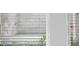 This window has a white frame with multiple panes of glass and blinds on the inside at 8632 Snowfall St, Sarasota, FL 34241