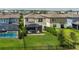 A beautifully maintained backyard with a screened in patio, green grass, and a fenced pool at 9148 Royal River Cir, Parrish, FL 34219
