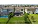 Aerial view of backyard with pool, patio, and well-maintained lawn at 9148 Royal River Cir, Parrish, FL 34219