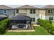 This backyard features a screened-in patio with stylish pavers and lush landscaping, perfect for outdoor gatherings at 9148 Royal River Cir, Parrish, FL 34219