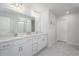 Bright bathroom with double vanity, modern fixtures, and a spacious walk-in shower at 9148 Royal River Cir, Parrish, FL 34219