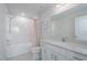Well-lit bathroom with white vanity, subway tile shower, and large mirror at 9148 Royal River Cir, Parrish, FL 34219