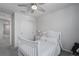 Bright bedroom with a white crib, closet, and carpeted floor at 9148 Royal River Cir, Parrish, FL 34219