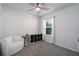Bedroom featuring a comfortable chair, shelving unit, and bright window at 9148 Royal River Cir, Parrish, FL 34219