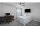 Well-lit bedroom with desk, TV, ceiling fan, and carpet at 9148 Royal River Cir, Parrish, FL 34219