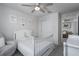 Bedroom with white crib, floral prints, and carpeted floor at 9148 Royal River Cir, Parrish, FL 34219