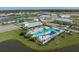 Aerial view of a community pool area with palm trees and a unique blue accent pattern at 9148 Royal River Cir, Parrish, FL 34219