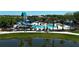 Upscale community pool and splashpad with mature palm trees, plenty of lounge seating, and a water slide at 9148 Royal River Cir, Parrish, FL 34219