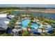 Resort-style community pool surrounded by palm trees and ample lounge seating, creating an oasis for relaxation at 9148 Royal River Cir, Parrish, FL 34219