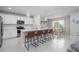 Bright, open kitchen featuring a white quartz island with bar stool seating, stainless appliances, and bright white cabinets at 9148 Royal River Cir, Parrish, FL 34219