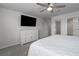 Spacious main bedroom with ceiling fan, flat screen TV, and dresser for ample storage at 9148 Royal River Cir, Parrish, FL 34219