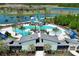 Aerial view of a community waterpark, complete with slides and pools, set against a scenic lake backdrop at 9148 Royal River Cir, Parrish, FL 34219