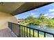 Charming balcony offers a lovely view of the pond with fountain and surrounding landscape at 933 Sunridge Way # B5, Sarasota, FL 34234