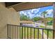Balcony with views of the community, carport, landscaping, and blue skies at 933 Sunridge Way # B5, Sarasota, FL 34234