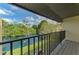 Relaxing balcony view overlooking lush greenery and a serene pond with a fountain at 933 Sunridge Way # B5, Sarasota, FL 34234
