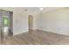 Open bedroom with light wood-look floors, closet, and a ceiling fan at 933 Sunridge Way # B5, Sarasota, FL 34234