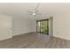 Large bedroom with wood-look floors, closet, and sliding doors to the balcony at 933 Sunridge Way # B5, Sarasota, FL 34234