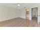 Large bedroom with ceiling fan, wood-look floors, and access to a bright bathroom at 933 Sunridge Way # B5, Sarasota, FL 34234