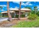 Community clubhouse with covered seating areas and well-maintained landscaping at 933 Sunridge Way # B5, Sarasota, FL 34234