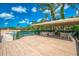 Spacious wooden deck area with tables and chairs, ideal for outdoor relaxation and dining at 933 Sunridge Way # B5, Sarasota, FL 34234