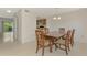 Dining room with a view of the screened patio and kitchen at 933 Sunridge Way # B5, Sarasota, FL 34234