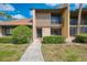 Charming condo entrance with manicured bushes, complemented by a lush green lawn at 933 Sunridge Way # B5, Sarasota, FL 34234