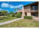 A well maintained condo with a grassy lawn and mature trees in a serene community at 933 Sunridge Way # B5, Sarasota, FL 34234