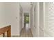 Bright hallway with wood-look floors, closet doors, and access to an outdoor balcony at 933 Sunridge Way # B5, Sarasota, FL 34234