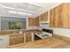 Well-lit kitchen with wood-style cabinets and essential appliances for convenient meal preparation at 933 Sunridge Way # B5, Sarasota, FL 34234