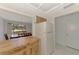 View from the kitchen showing the open floor plan to the dining room and the refrigerator at 933 Sunridge Way # B5, Sarasota, FL 34234