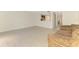 Open living area features neutral tile flooring and flows into adjacent rooms at 933 Sunridge Way # B5, Sarasota, FL 34234