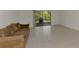Spacious living room with tile flooring, a comfortable couch, and an outdoor view of the lanai at 933 Sunridge Way # B5, Sarasota, FL 34234