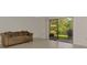 Cozy living room with a couch and sliding glass doors leading to the lanai at 933 Sunridge Way # B5, Sarasota, FL 34234
