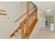 Staircase with wooden railing leading to the upper level of the home at 933 Sunridge Way # B5, Sarasota, FL 34234
