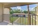 Balcony view of parking area and palm trees at 935 Sunridge Way # B4, Sarasota, FL 34234